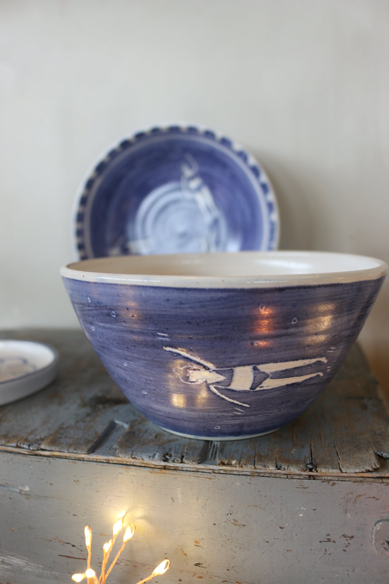 Blue and white handmade pottery bowl with male and female swimmers around the outside. Handmade 