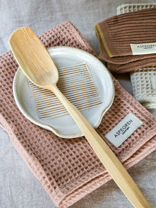 clay colour kitchen textiles with spoon and spoon rest